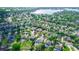 Aerial view showing the neighborhood and large lake nearby, surrounded by mature trees at 4901 Lake Milly Dr, Orlando, FL 32839