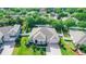 Aerial view of a well-maintained house with lush landscaping, a driveway, and a fenced backyard at 4901 Lake Milly Dr, Orlando, FL 32839