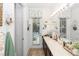 Bright bathroom with double sink vanity, decorative window, and ample counter space at 4901 Lake Milly Dr, Orlando, FL 32839
