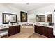 This bathroom features dual vanities, a soaking tub with tile surround, and natural light at 4901 Lake Milly Dr, Orlando, FL 32839