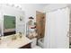 Guest bathroom featuring a tub with shower and a framed mirror at 4901 Lake Milly Dr, Orlando, FL 32839