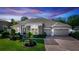 Charming single-story home boasts stone accents, manicured lawn, and a three-car garage at 4901 Lake Milly Dr, Orlando, FL 32839