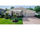 Beautifully landscaped single-story home with a brick driveway and well-maintained lawn at 4901 Lake Milly Dr, Orlando, FL 32839