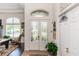 Elegant foyer featuring tile flooring and double glass doors at 4901 Lake Milly Dr, Orlando, FL 32839
