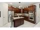 Gourmet kitchen featuring stainless steel appliances, granite countertops, and custom cabinetry at 4901 Lake Milly Dr, Orlando, FL 32839