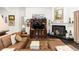 Comfortable living room featuring a brown leather sofa, fireplace and wooden entertainment center at 4901 Lake Milly Dr, Orlando, FL 32839