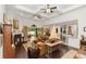 Expansive living room with fireplace, ceiling fans, and access to outdoor living space at 4901 Lake Milly Dr, Orlando, FL 32839