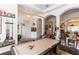 Beautifully decorated living room with a pool table and elegant chandelier at 4901 Lake Milly Dr, Orlando, FL 32839