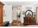 Bright main bedroom boasts wood floors and an antique dresser leading to the ensuite bath at 4901 Lake Milly Dr, Orlando, FL 32839