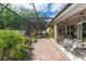 Enclosed patio area with comfortable seating and lush landscaping for relaxation and privacy at 4901 Lake Milly Dr, Orlando, FL 32839