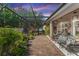 Enclosed patio area with comfortable seating and lush landscaping for relaxation and privacy at 4901 Lake Milly Dr, Orlando, FL 32839