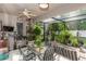Enclosed patio area with plants, dining, and ceiling fan perfect for outdoor dining at 4901 Lake Milly Dr, Orlando, FL 32839