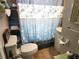 Bathroom featuring floral shower curtain and tile floor at 503 5Th Ave, Daytona Beach, FL 32118