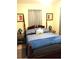 A quaint bedroom featuring a wooden bed frame, neutral walls, and matching bedside lamps at 503 5Th Ave, Daytona Beach, FL 32118