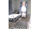 Cozy bedroom with neutral decor, a single bed, tile floor, and an area rug at 503 5Th Ave, Daytona Beach, FL 32118
