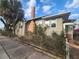 Home exterior showing the side of house with brick chimney, trees and fence at 503 5Th Ave, Daytona Beach, FL 32118