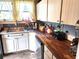 Bright kitchen with white cabinets, stainless steel appliances and butcher block countertop at 503 5Th Ave, Daytona Beach, FL 32118