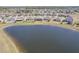 A panoramic aerial view showcases lakeside homes with screened patios nestled within a tranquil community at 5298 Bear Corn Run, Port Orange, FL 32128