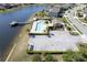 An aerial view features a community pool, sun deck, parking lot, and lake access at 5298 Bear Corn Run, Port Orange, FL 32128