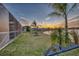 Spacious backyard with a lake view, complemented by a fire pit and lush landscaping, ideal for outdoor enjoyment at 5298 Bear Corn Run, Port Orange, FL 32128