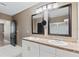 Bright bathroom featuring double mirrors and sinks at 5298 Bear Corn Run, Port Orange, FL 32128