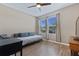 Cozy bedroom with neutral paint, wood floors, and ample natural light at 5298 Bear Corn Run, Port Orange, FL 32128