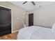 Inviting bedroom with a ceiling fan, wood floors, and an open doorway at 5298 Bear Corn Run, Port Orange, FL 32128