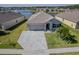 Charming single-Gathering home with a well-manicured lawn, attached garage, and inviting entryway at 5298 Bear Corn Run, Port Orange, FL 32128