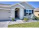 Inviting front entrance with meticulously landscaped garden beds, enhancing curb appeal and charm at 5298 Bear Corn Run, Port Orange, FL 32128