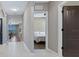 Hallway view showcasing neutral paint and tile floors, with views to other rooms at 5298 Bear Corn Run, Port Orange, FL 32128