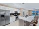 Open kitchen with stainless steel appliances, white cabinets, and granite countertops at 5298 Bear Corn Run, Port Orange, FL 32128