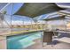 Enclosed pool area with lounge chairs, overlooking the lake and perfect for relaxation at 5298 Bear Corn Run, Port Orange, FL 32128