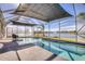 Sparkling pool with a built-in waterfall feature, all within a screened enclosure overlooking the tranquil lake at 5298 Bear Corn Run, Port Orange, FL 32128