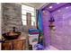 Unique bathroom featuring custom tiling, modern fixtures, and a glass bowl sink with artistic decor at 600 Holmes Ave, Daytona Beach, FL 32114