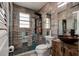 Updated bathroom featuring a stylish vanity and glass enclosed shower with stone tile flooring at 600 Holmes Ave, Daytona Beach, FL 32114