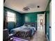 This bedroom has vibrant green walls, a multicolored ceiling fan, and new tile flooring throughout at 600 Holmes Ave, Daytona Beach, FL 32114