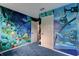Bedroom featuring custom ocean themed wallpaper and plush blue carpeting at 600 Holmes Ave, Daytona Beach, FL 32114