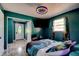 A bedroom that has natural lighting and features vibrant green walls and new tile flooring throughout at 600 Holmes Ave, Daytona Beach, FL 32114