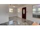 Inviting foyer showcasing new tile flooring and an ornate front door and natural light at 600 Holmes Ave, Daytona Beach, FL 32114