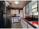View of the kitchen featuring a black fridge, tiled floors, and sleek counter tops and sink at 600 Holmes Ave, Daytona Beach, FL 32114