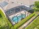 Aerial view of a screened pool with a water feature, surrounded by a well-manicured backyard at 669 E Victoria Trails Blvd, Deland, FL 32724