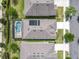 Overhead view of the house showing solar panels and screened-in pool in a well maintained neighborhood at 669 E Victoria Trails Blvd, Deland, FL 32724