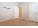 A standard bedroom with neutral colors, tile floor, and standard doors at 669 E Victoria Trails Blvd, Deland, FL 32724