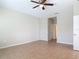 Simple bedroom features tile flooring, a ceiling fan and neutral colored walls at 669 E Victoria Trails Blvd, Deland, FL 32724