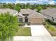 Charming single-story home with a neat lawn, an attached two-car garage, and tasteful exterior finishes at 669 E Victoria Trails Blvd, Deland, FL 32724