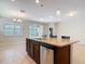 Kitchen island featuring granite countertops, a stainless steel dishwasher, and stylish pendant lighting in an open floor plan at 669 E Victoria Trails Blvd, Deland, FL 32724