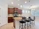 Spacious kitchen with granite countertops, stainless steel appliances, dark cabinetry, and an island with bar seating at 669 E Victoria Trails Blvd, Deland, FL 32724