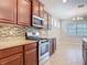 Bright kitchen showcasing stainless steel appliances, granite counters, dark wood cabinetry, and pendant lighting over the island at 669 E Victoria Trails Blvd, Deland, FL 32724