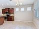Eat-in kitchen features stainless appliances, granite countertops, and dark wood cabinets at 669 E Victoria Trails Blvd, Deland, FL 32724