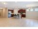 Open-concept kitchen with stainless steel appliances, dark wood cabinetry, and a spacious island, perfect for modern living at 669 E Victoria Trails Blvd, Deland, FL 32724